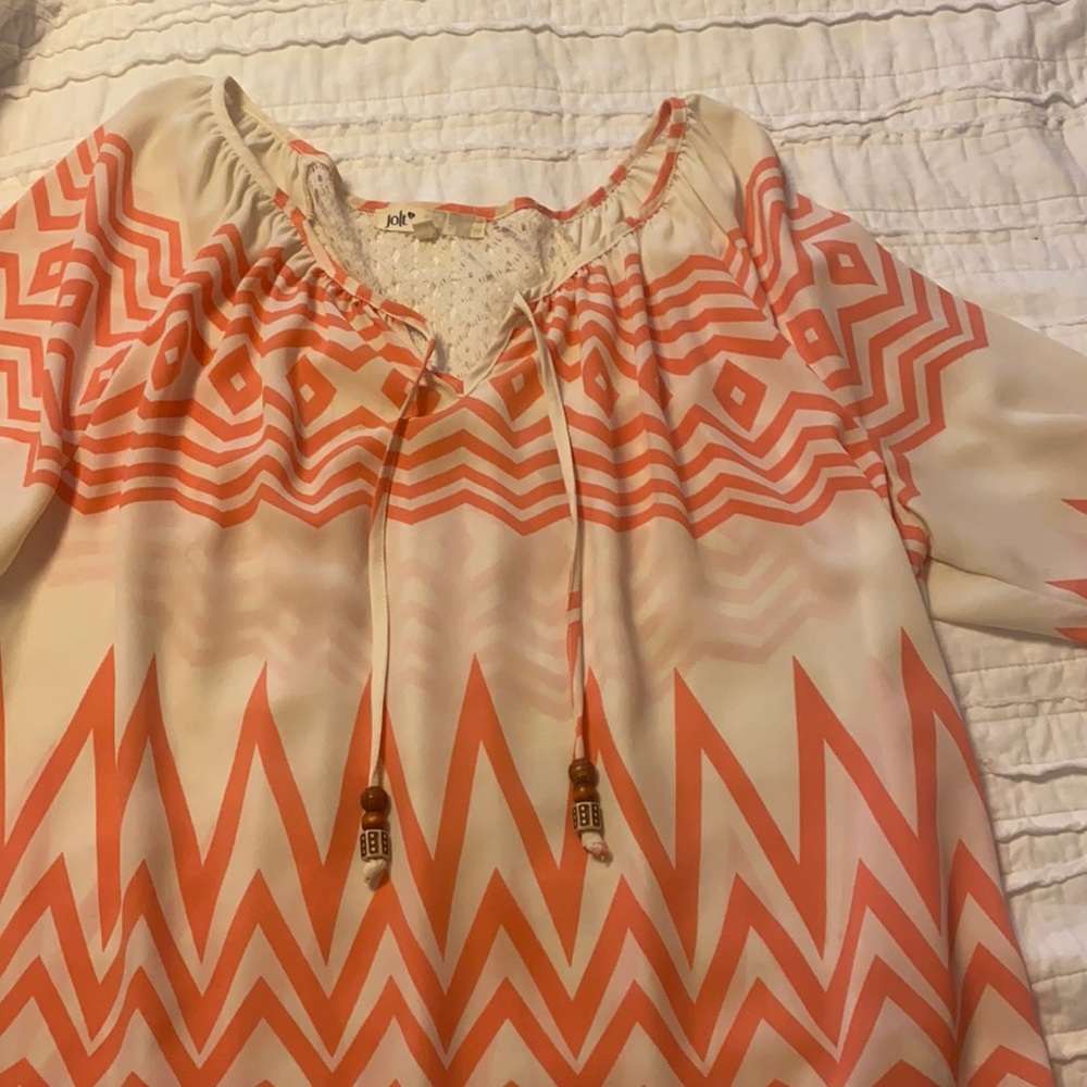 Coral and cream blouse